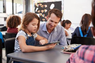 student and teacher working